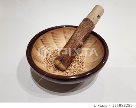 Sesame Seeds or Perilla Seeds in Traditional Ceramic Bowl and Mortar 135958283