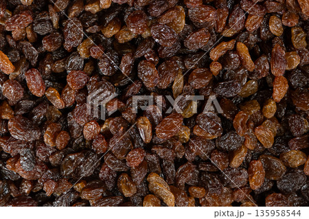Macro top view of dried grapes, sweet organic raisins. Macro top view of dried grapes, sweet organic raisins. 135958544