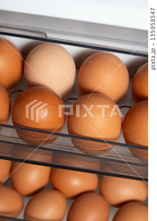 Fresh brown chicken eggs on refrigerator door shelves. Fresh brown chicken eggs on refrigerator door shelves. 135958547