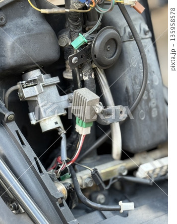 Car engine compartment showing wiring and mechanical components for automotive maintenance 135958578