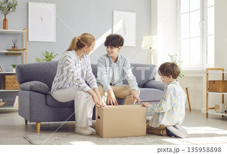Mother With Children, Sons, Unpacking Package Or Parcel 135958898