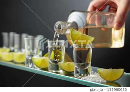Tequila shots with salt and lime slices. 135960656
