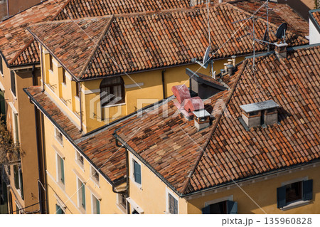 Aerial view of the rooftops in Verona, Italy, showcasing traditional architecture. Aerial view of the rooftops in Verona, Italy, showcasing traditional architecture. 135960828