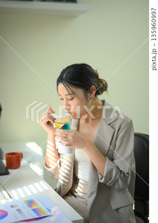 Office worker eating instant noodles at desk, fast meal choice highlighting convenience versus long term health risks Office worker eating instant noodles at desk, fast meal choice highlighting convenience versus long term health risks 135960997