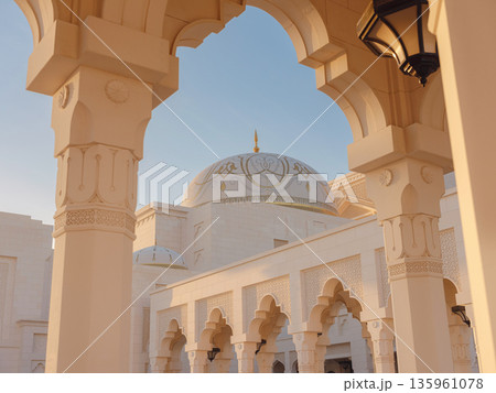 Elegant exterior showcases traditional Arabic design elements with ornate arches and decorative lanterns. White marble walls and geometric patterns create authentic oriental atmosphere 135961078