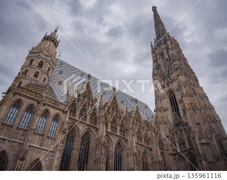 Summer view of Vienna Stephansplatz with iconic cathedral and surrounding old town streets, historic architecture, lively city atmosphere, European travel destination, cultural urban scene. Summer view of Vienna Stephansplatz with iconic cathedral and surrounding old town streets, historic architecture, lively city atmosphere, European travel destination, cultural urban scene. 135961116