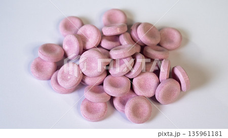 Pink Candies On White Background, Confectionery Arrangement Against Neutral Backdrop, Bright Pink Candy Pieces Displayed On White Studio Surface Suitable For Advertising Imagery Pink Candies On White Background, Confectionery Arrangement Against Neutral Backdrop, Bright Pink Candy Pieces Displayed On White Studio Surface Suitable For Advertising Imagery 135961181