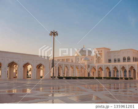 Qasr Al Watan Palace Exterior Architecture Abu Dhabi UAE Description: Magnificent white facade of Qasr Al Watan presidential palace stands under clear blue sky. modern Islamic design in Abu Dhabi. Qasr Al Watan Palace Exterior Architecture Abu Dhabi UAE Description: Magnificent white facade of Qasr Al Watan presidential palace stands under clear blue sky. modern Islamic design in Abu Dhabi. 135961201