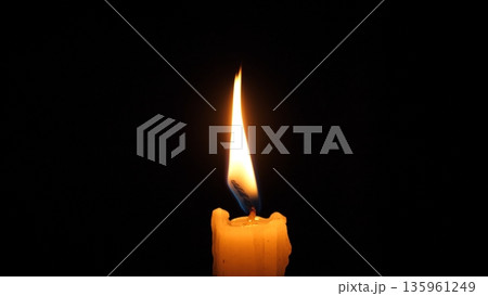 Single Candle Flame Flickering In Darkness, Soft Wax Drips Forming Textured Silhouette, Warm Amber Glow Creating Intimate, Contemplative Mood For Meditation And Remembrance Single Candle Flame Flickering In Darkness, Soft Wax Drips Forming Textured Silhouette, Warm Amber Glow Creating Intimate, Contemplative Mood For Meditation And Remembrance 135961249