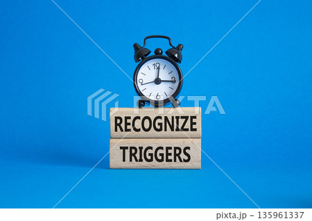 Recognize triggers symbol. Concept words Recognize triggers on wooden blocks. Beautiful blue background with alarm clock. Business and Recognize triggers concept. Copy space. 135961337
