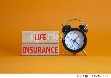 Life insurance symbol. Concept word Life insurance on wooden blocks. Beautiful orange background with alarm clock. Business and Life insurance concept. Copy space Life insurance symbol. Concept word Life insurance on wooden blocks. Beautiful orange background with alarm clock. Business and Life insurance concept. Copy space 135961345