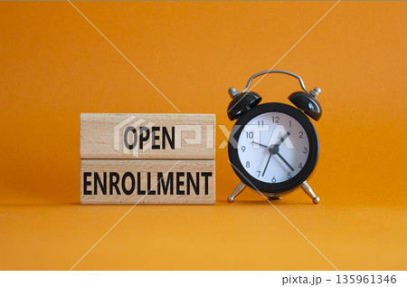 Open Enrollment symbol. Wooden blocks with words Open Enrollment. Beautiful orange background with alarm clock. Business and Open Enrollment concept. Copy space. 135961346