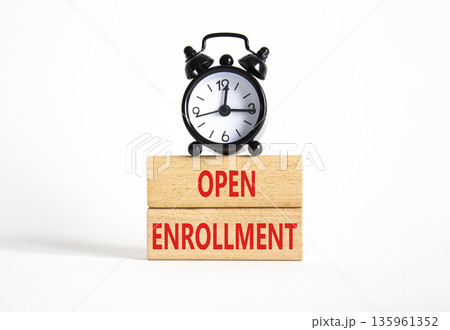 Open Enrollment symbol. Wooden blocks with words Open Enrollment. Beautiful white background with alarm clock. Business and Open Enrollment concept. Copy space. 135961352