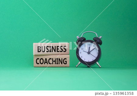 Business Coaching symbol. Wooden blocks with words Business Coaching. Beautiful green background with alarm clock. Business and Business Coaching concept. Copy space. 135961358