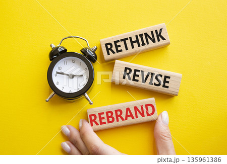Rethink Revise Rebrand symbol. Wooden blocks with words Rethink Revise Rebrand. Businessman hand. Beautiful yellow background with alarm clock. Business and Rethink Revise Rebrand concept. Copy space. Rethink Revise Rebrand symbol. Wooden blocks with words Rethink Revise Rebrand. Businessman hand. Beautiful yellow background with alarm clock. Business and Rethink Revise Rebrand concept. Copy space. 135961386