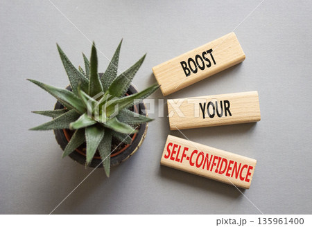 Self-confidence symbol. Concept word Boost your Self-confidence on wooden blocks with succulent. Beautiful grey background. Business lifestyle and Self-confidence concept. Copy space Self-confidence symbol. Concept word Boost your Self-confidence on wooden blocks with succulent. Beautiful grey background. Business lifestyle and Self-confidence concept. Copy space 135961400