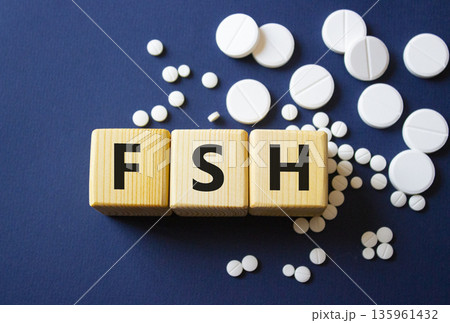 FSH symbol. Wooden cubes with words FSH Follicle stimulating hormone. Beautiful deep blue background. Healthcare and Follicle stimulating hormone concept. Copy space. FSH symbol. Wooden cubes with words FSH Follicle stimulating hormone. Beautiful deep blue background. Healthcare and Follicle stimulating hormone concept. Copy space. 135961432