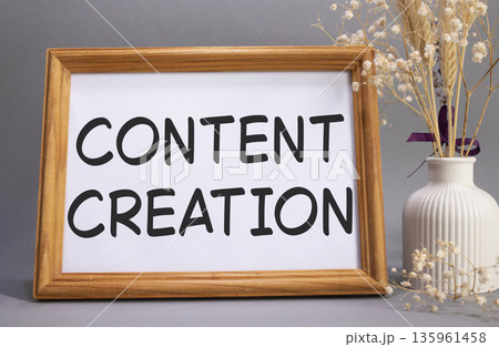 Content creation symbol. Concept words Content creation on beautiful wooden picture frame. Beautiful grey background with flower vase. Business and Content creation concept. Copy space. 135961458