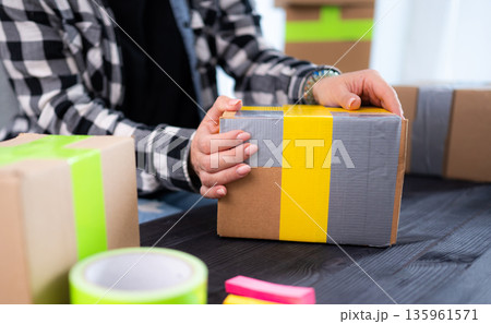 Girl Packing Cardboard Box At Home 135961571