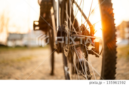 Rear Wheel Of Mountain Bike At Sunset 135961592
