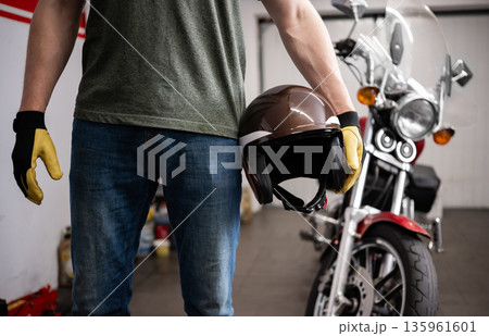 Man Holding Protective Moto Helmet 135961601
