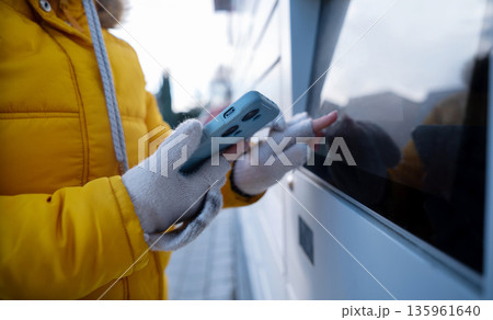 Girl Picking Up A Parcel From Parcel Automated Locker 135961640