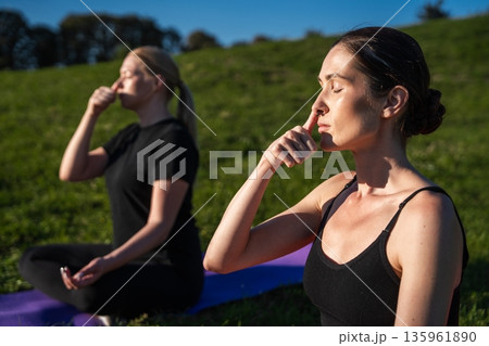 Relaxation and mindfulness practices in the serene outdoors of a park Relaxation and mindfulness practices in the serene outdoors of a park 135961890
