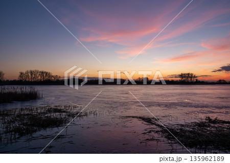 Sunset view of the frozen lake 135962189