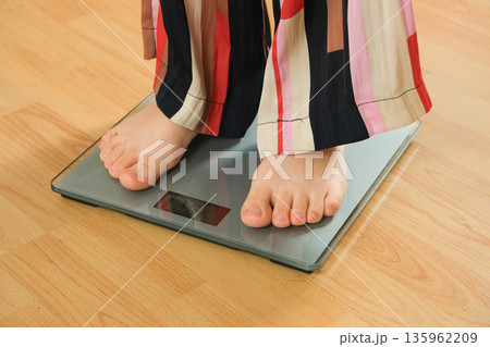 Bare Feet Standing on Modern Digital Bathroom Scales for Weighing. 135962209