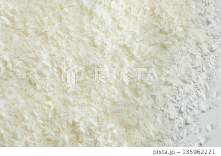 Pile of coconut flakes on white background macro 135962221