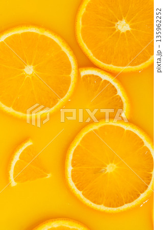 Vertical macro of orange slices in fresh juice, mobile wallpaper. Vertical macro of orange slices in fresh juice, mobile wallpaper. 135962252