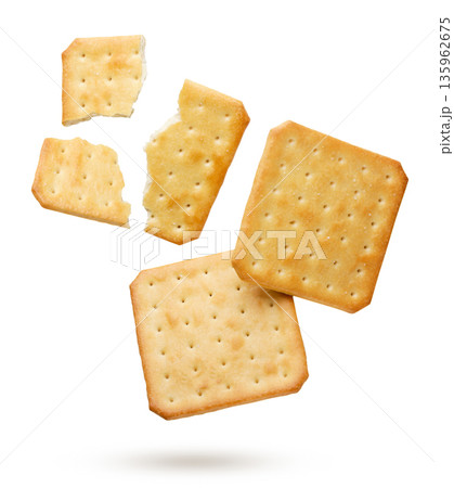 Crackers and broken pieces flying on a white background. Isolated Crackers and broken pieces flying on a white background. Isolated 135962675