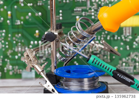 electrical board with a soldering iron and screwdrivers electrical board with a soldering iron and screwdrivers 135962738
