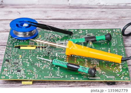 electrical board with a soldering iron and screwdrivers electrical board with a soldering iron and screwdrivers 135962779