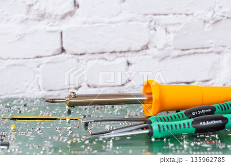 electrical board with a soldering iron and screwdrivers electrical board with a soldering iron and screwdrivers 135962785