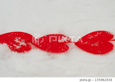 red hearts on the snow= 135962838