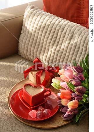 Heart Shaped Coffee Cup with Colorful Tulips and Candies. Cozy Romantic Flatlay on Sofa for Valentines Day Celebration 135962967