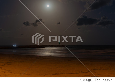 Night Beach with Full Moon and Gentle Waves 135963397