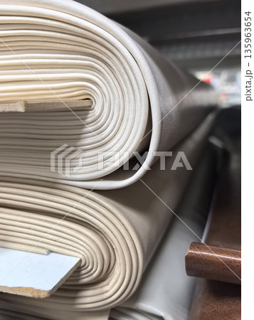 Rolls of soft materials stacked in a workshop for crafting projects 135963654