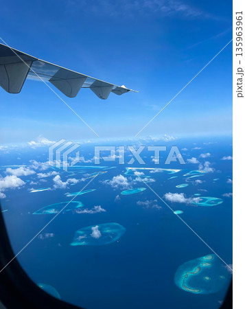A plane is flying through the sky with a tail wing A plane is flying through the sky with a tail wing 135963961