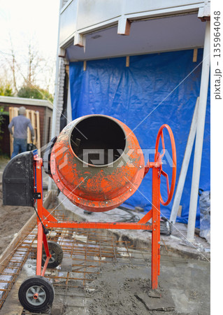 Portable Concrete Mixer on Construction Site with Rebar Reinforcement  135964048