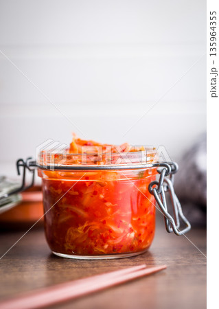 Fermented cabbage. Kimchi. Korean food in jar on wooden table. Fermented cabbage. Kimchi. Korean food in jar on wooden table. 135964355