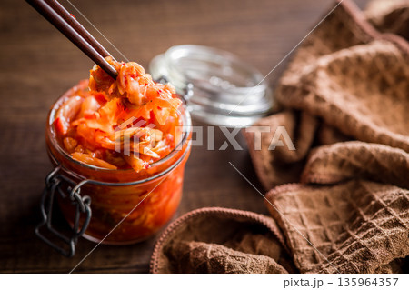 Fermented cabbage. Kimchi. Korean food in jar on wooden table. Fermented cabbage. Kimchi. Korean food in jar on wooden table. 135964357