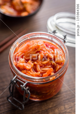 Fermented cabbage. Kimchi. Korean food in jar on wooden table. Fermented cabbage. Kimchi. Korean food in jar on wooden table. 135964366