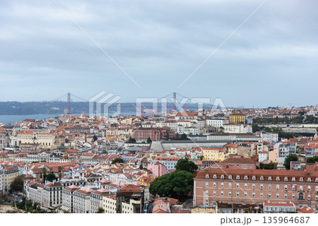 Lisbon Alfama Skyline with Sao Jorge Castle and 25 de Abril Bridge on a Cloudy Day 135964687