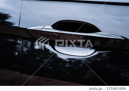 Modern Black Car Door Handle Close Up Modern Black Car Door Handle Close Up 135965899