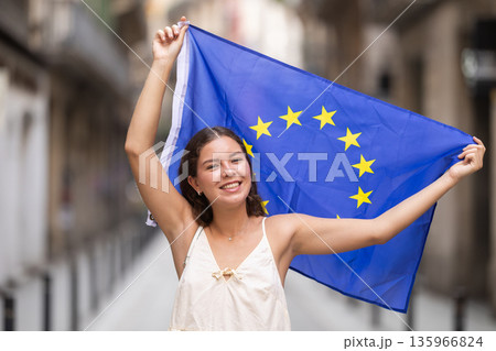 Young woman with EU flag on city street 135966824
