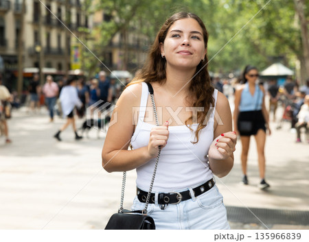 Happy young female tourist strolling along La Rambla in Barcelona 135966839