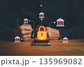 Businessman using smartphone with glowing lock icon and digital bank network, symbolizing cybersecurity, online banking protection, financial data security, and secure digital transaction concept. 135969082