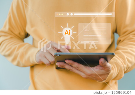 Person using tablet with AI innovation and light bulb icon, representing artificial intelligence, digital creativity, smart technology development, modern innovation, and intelligent solution concept. 135969104